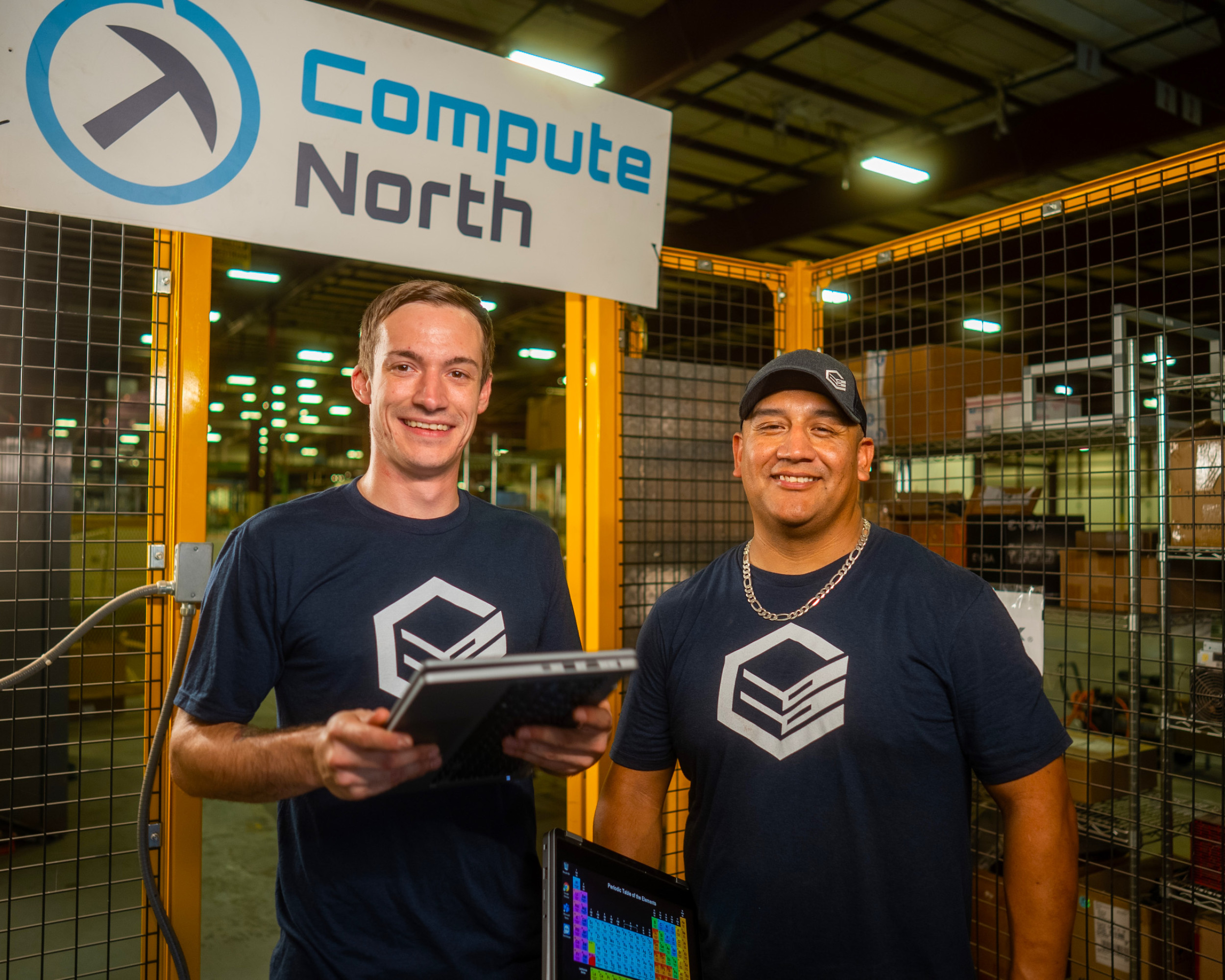 Two Compute North employees standing together
